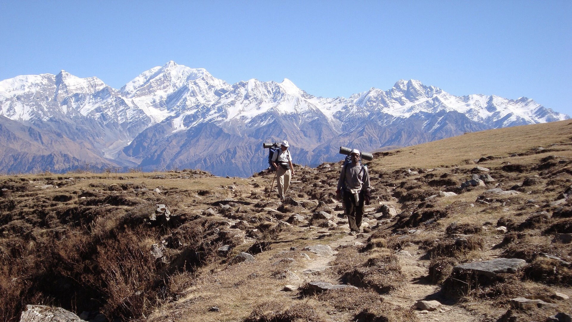 Trekkers traversing a high Himalayan ridge