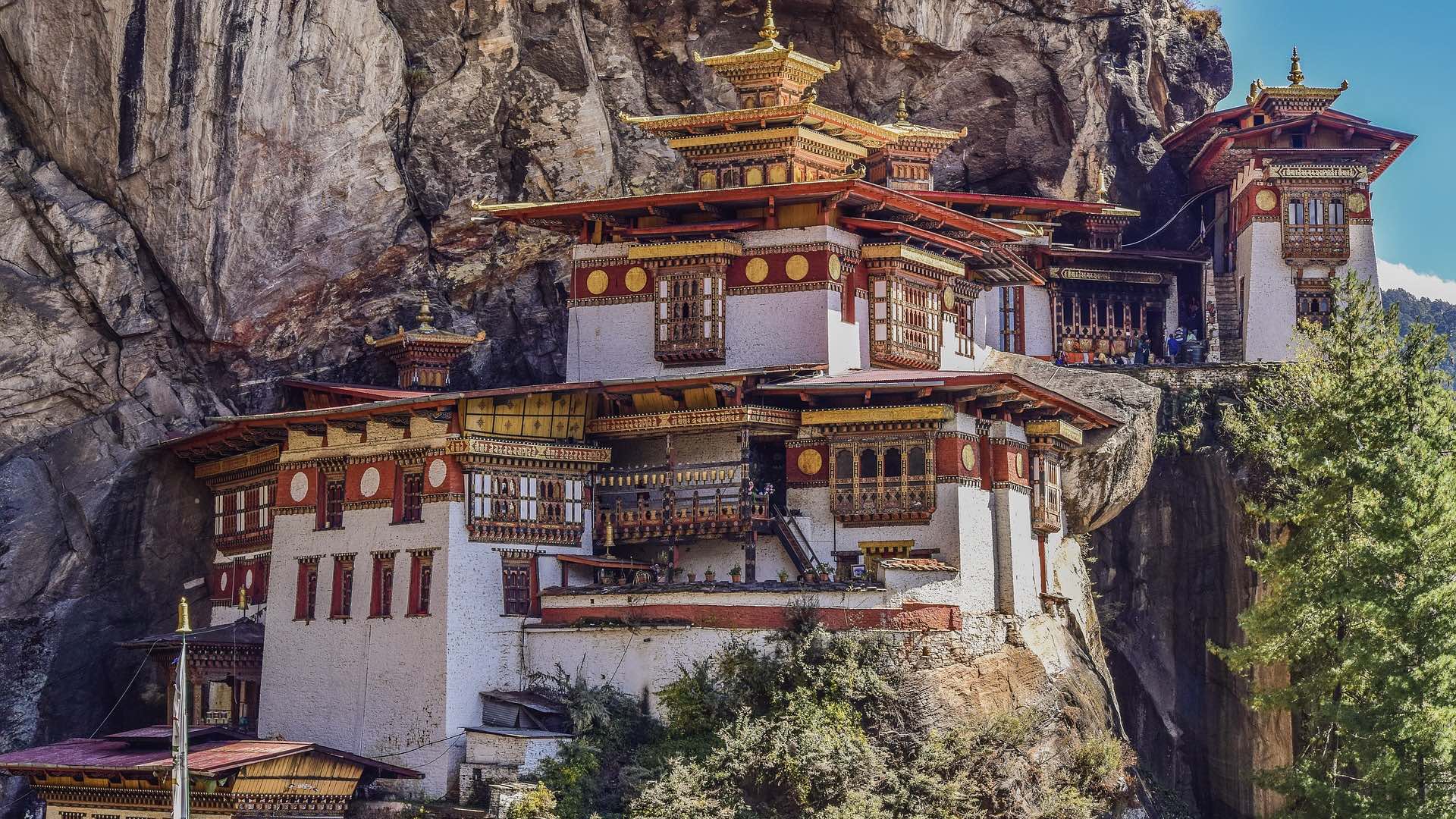 Stone dzong rising above a Bhutanese valley