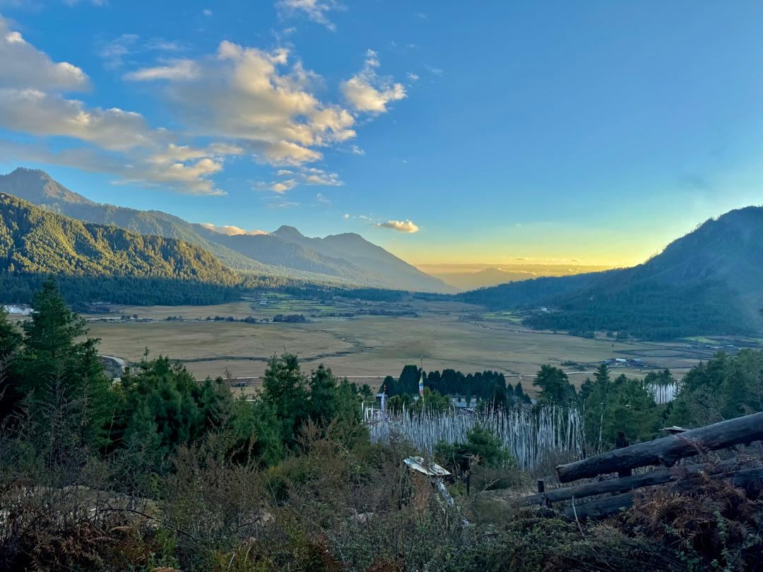 Last light over the flat floor of the Khotokha valley, forested ridges on both sides