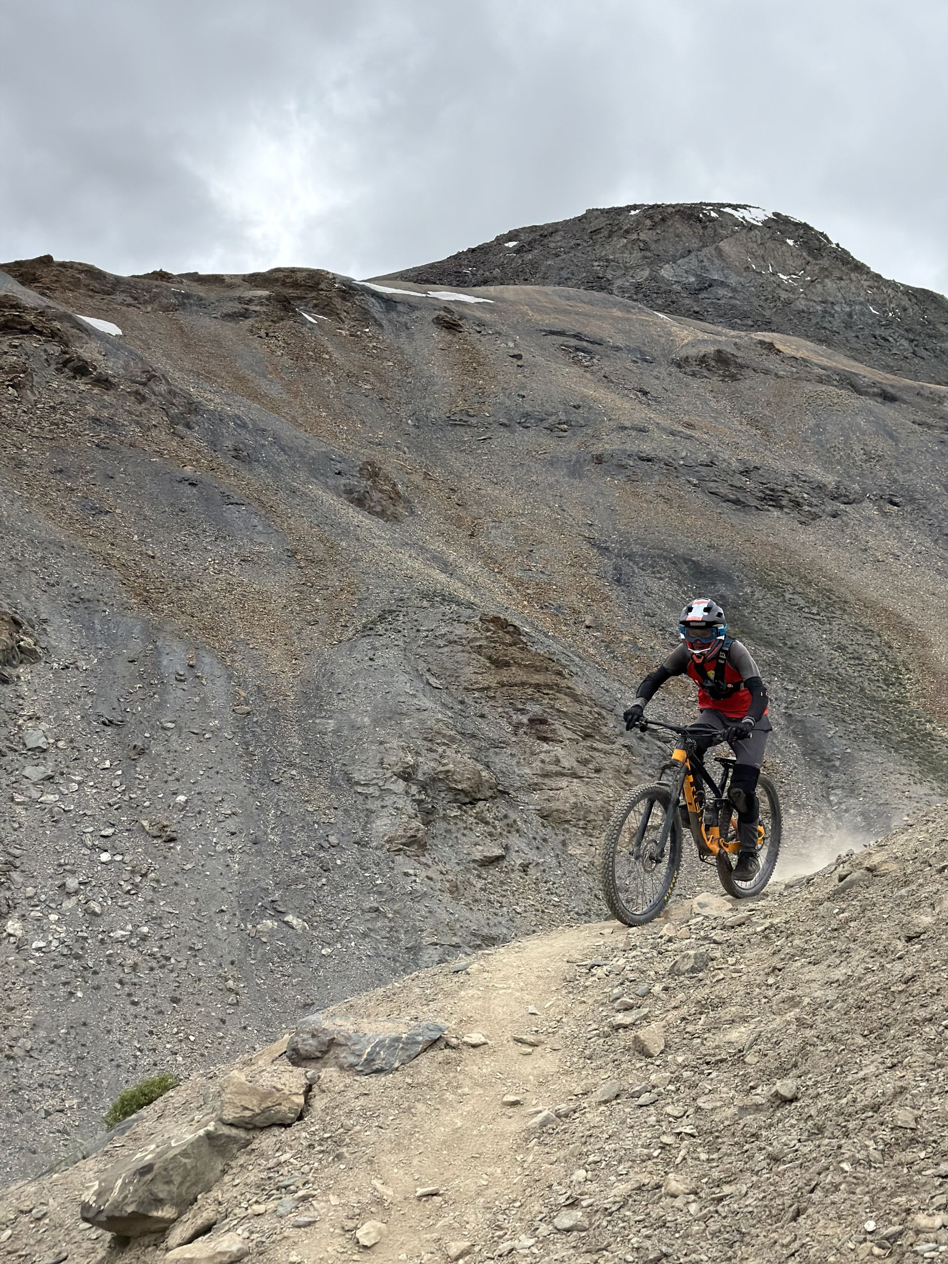 Rider dropping into the high line above Nerak village in Zanskar